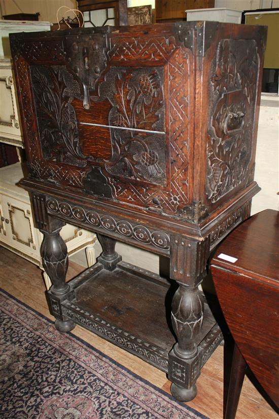 Carved oak metal bound chest on stand